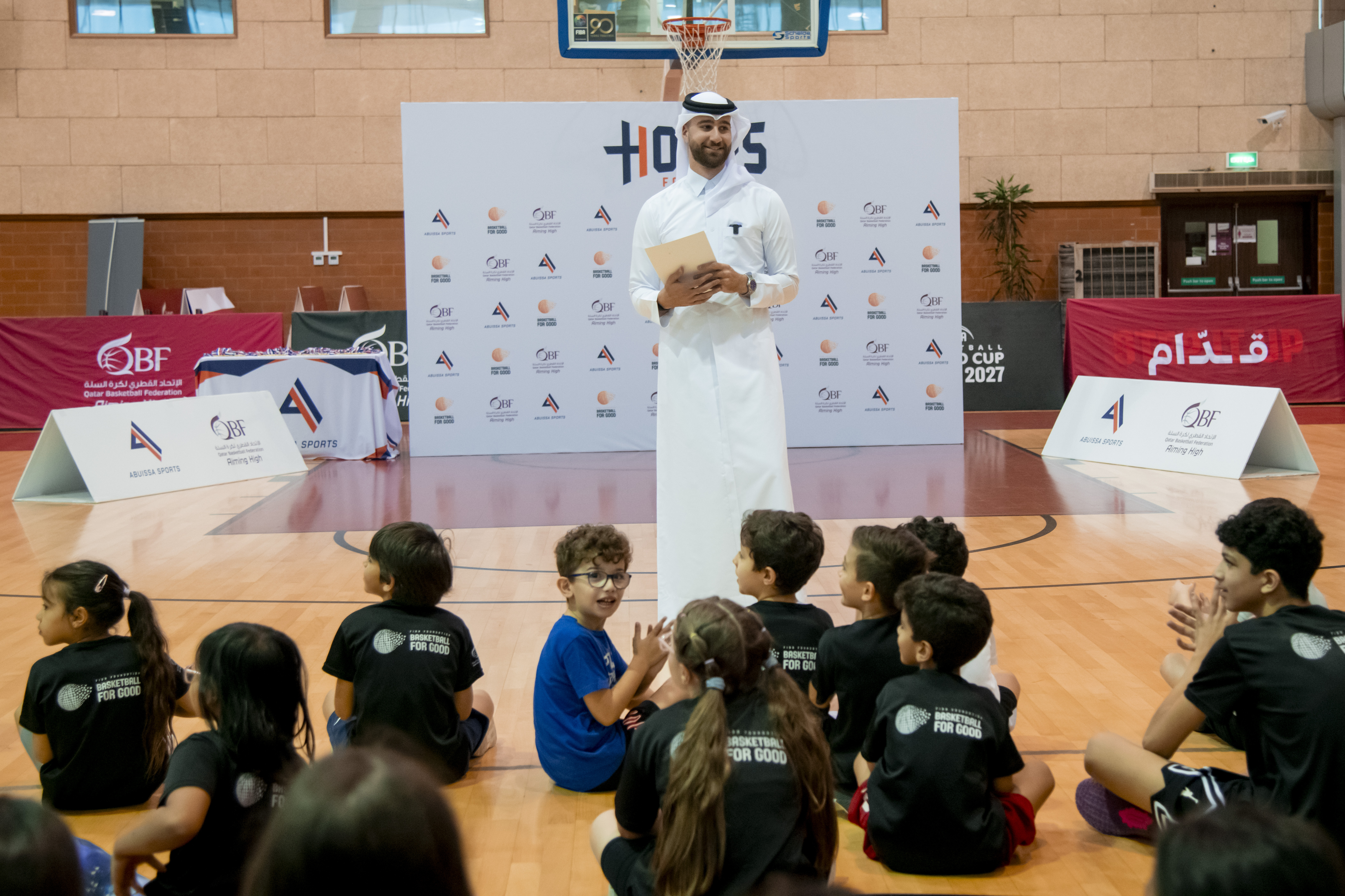 Abdulrahim Abuissa in traditional Qatari dress at a Basketball for Good community event